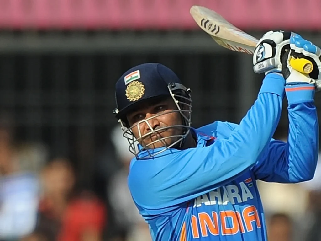 Virender Sehwag celebrates 219 runs, double century in ODI against West Indies.